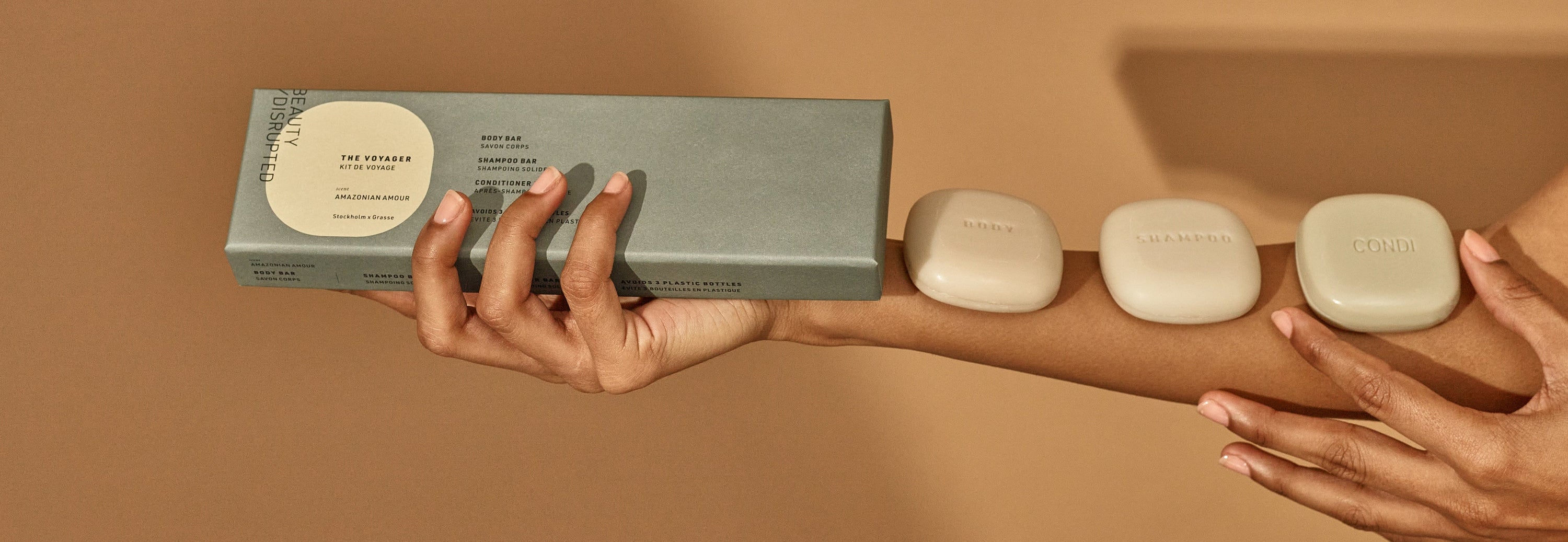 Beauty Disrupted Voyager travel ritual — solid shampoo, conditioner and body bars outside their case, ready for carry-on travel